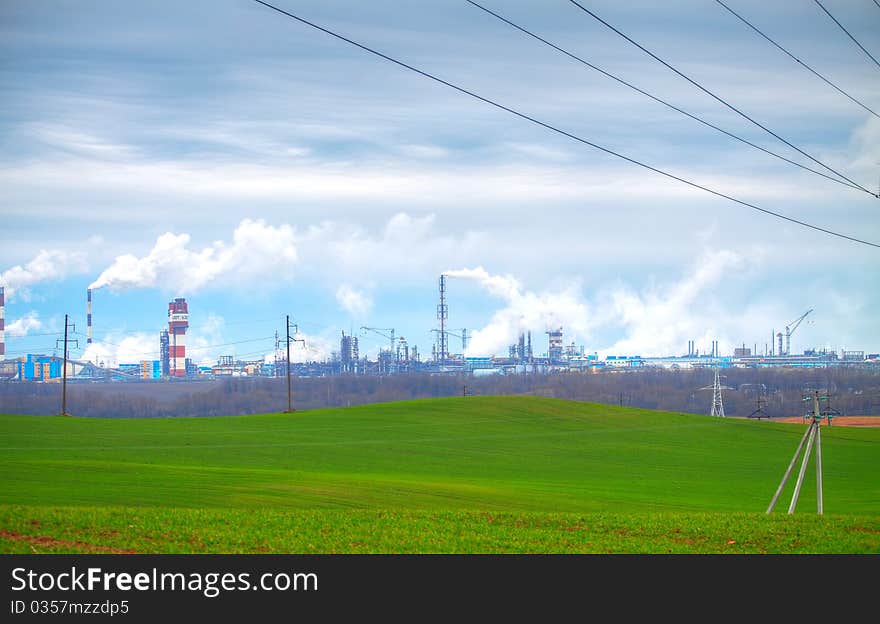 Factory on manufacture of nitric fertilizers with the elevating crane, represented against the blue sky. Factory on manufacture of nitric fertilizers with the elevating crane, represented against the blue sky