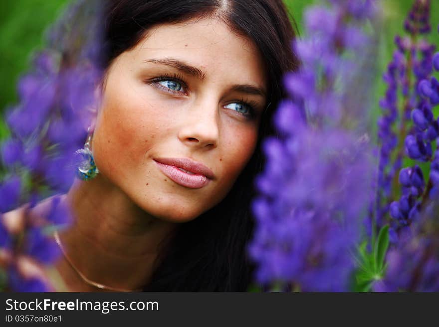 Woman on pink flower field close portrait