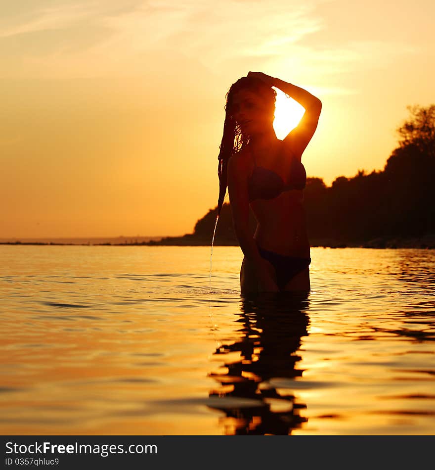 Ocean woman in sunrise light. Ocean woman in sunrise light