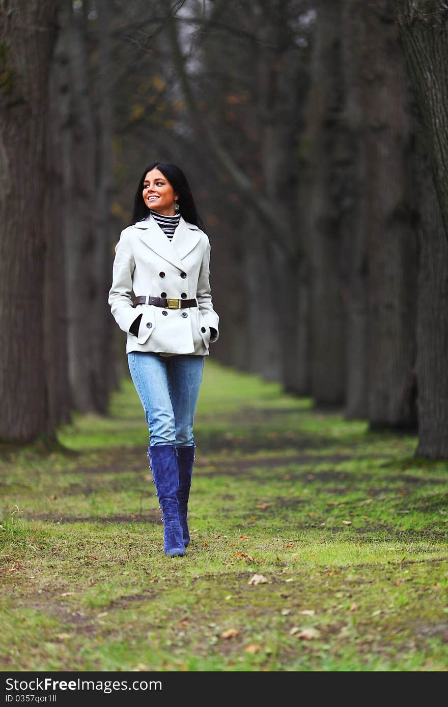 Woman going by autumn park. Woman going by autumn park