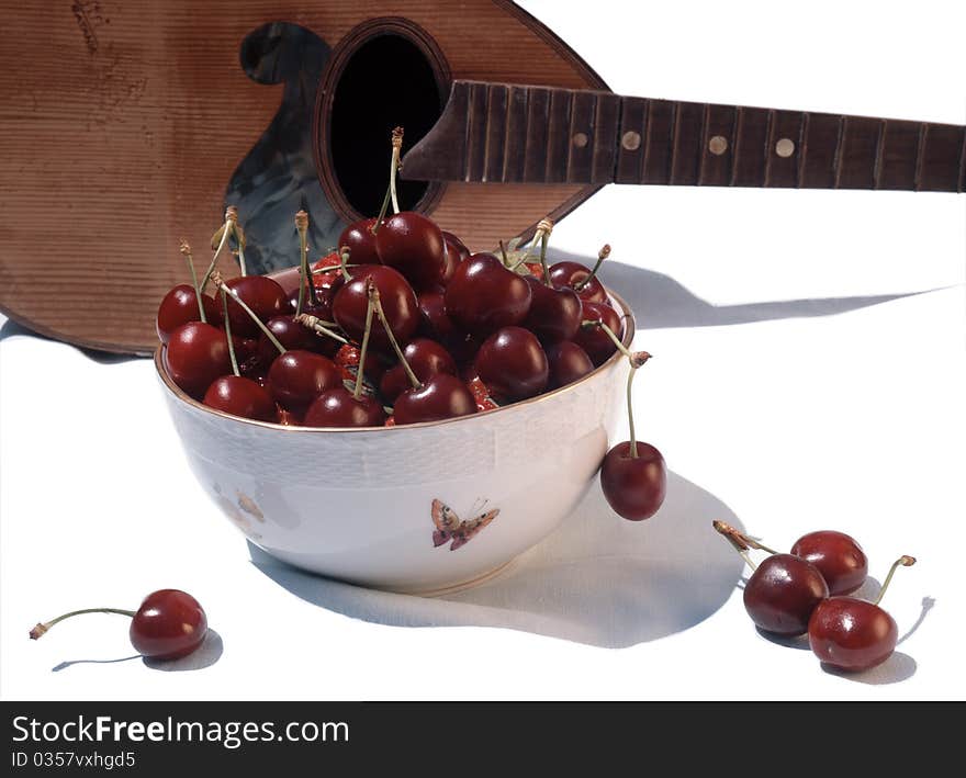 Scene of cherry with mandolin isolated on white background