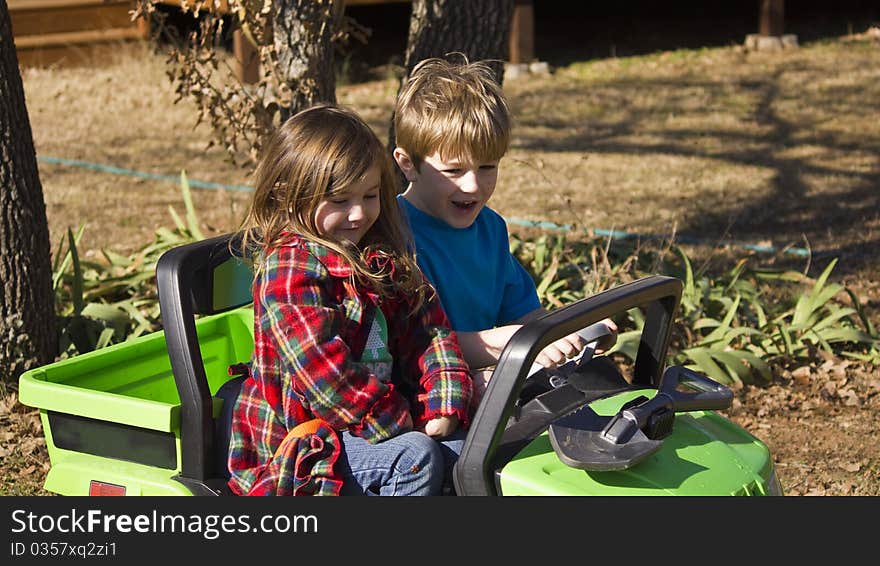 Girl and Boy riding in a small car and enjoying themselves. Girl and Boy riding in a small car and enjoying themselves