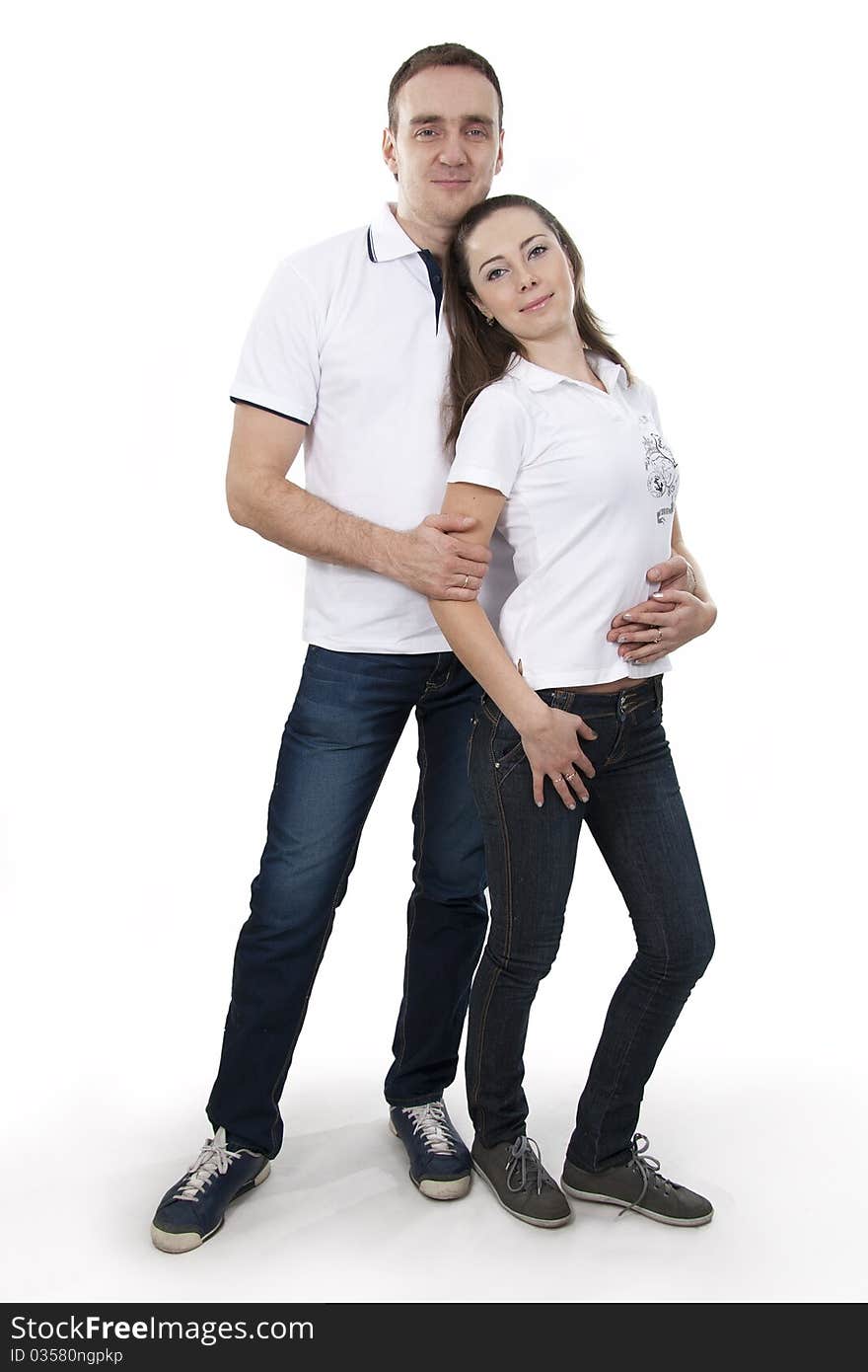 Young adults man and woman in casual style stand on white isolation. Young adults man and woman in casual style stand on white isolation