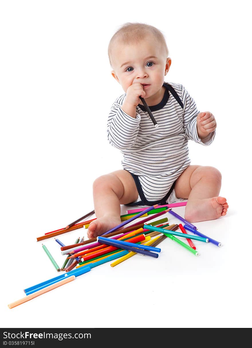 A little cute boy with markers and pencils. isolated on a white background