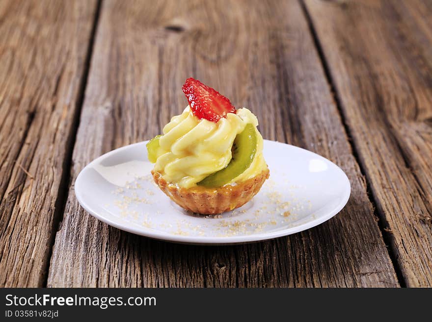 Fruit-topped tart with custard filling - closeup. Fruit-topped tart with custard filling - closeup