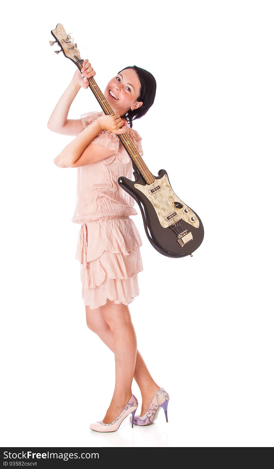 A beautiful smiling woman is holding the electro guitar. isolated on a white background. A beautiful smiling woman is holding the electro guitar. isolated on a white background