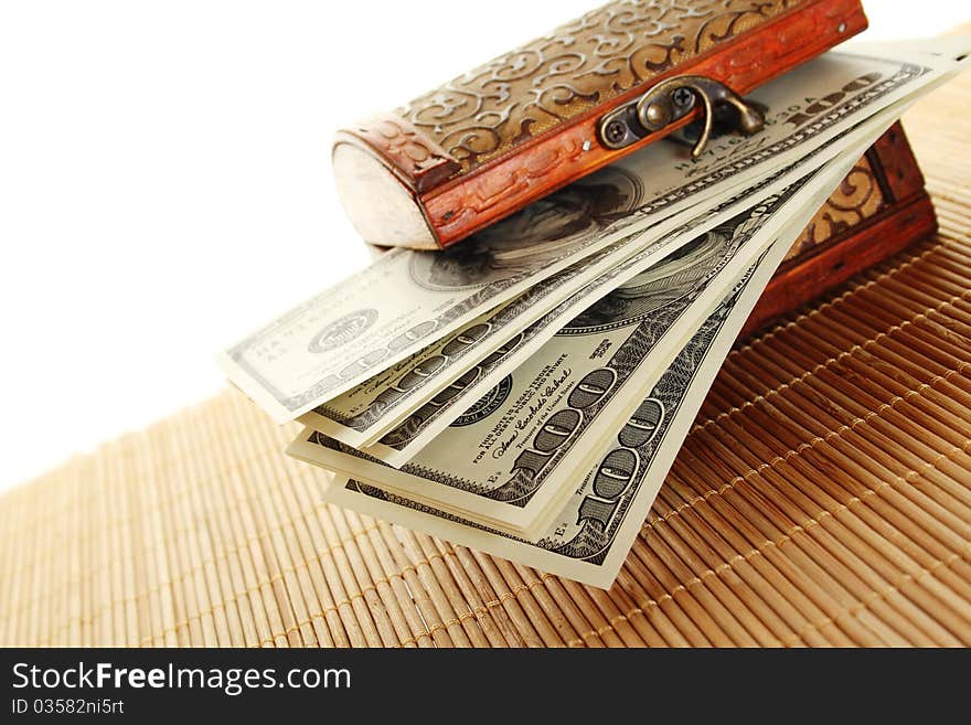 Toy wooden chest filled with the new one hundred dollar bills. Isolated on a white background. Toy wooden chest filled with the new one hundred dollar bills. Isolated on a white background