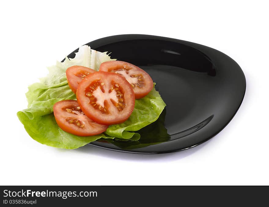 Tomatoes and salad on plate. Tomatoes and salad on plate