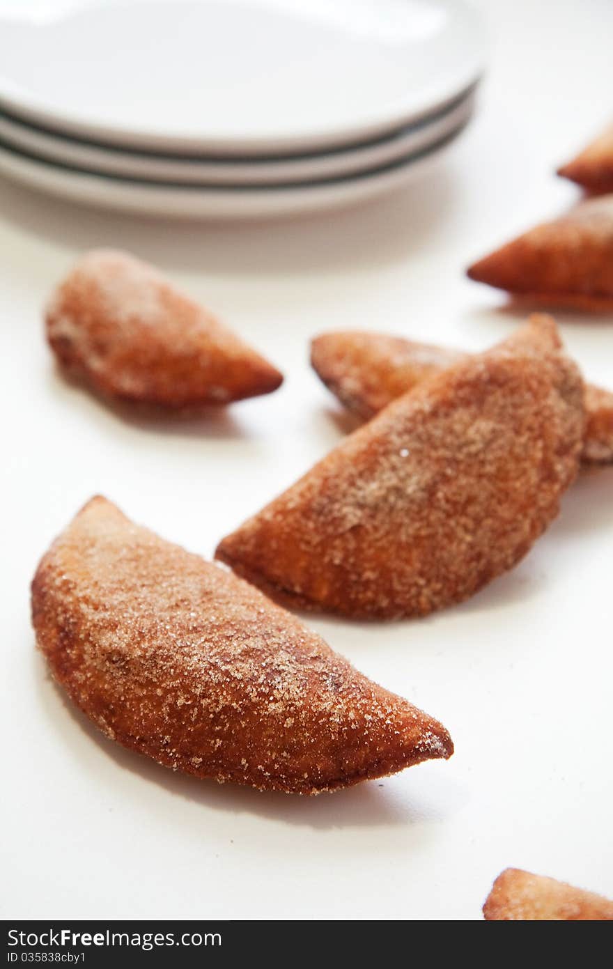 An abundance of Sweet fried cherry turnovers on white. An abundance of Sweet fried cherry turnovers on white