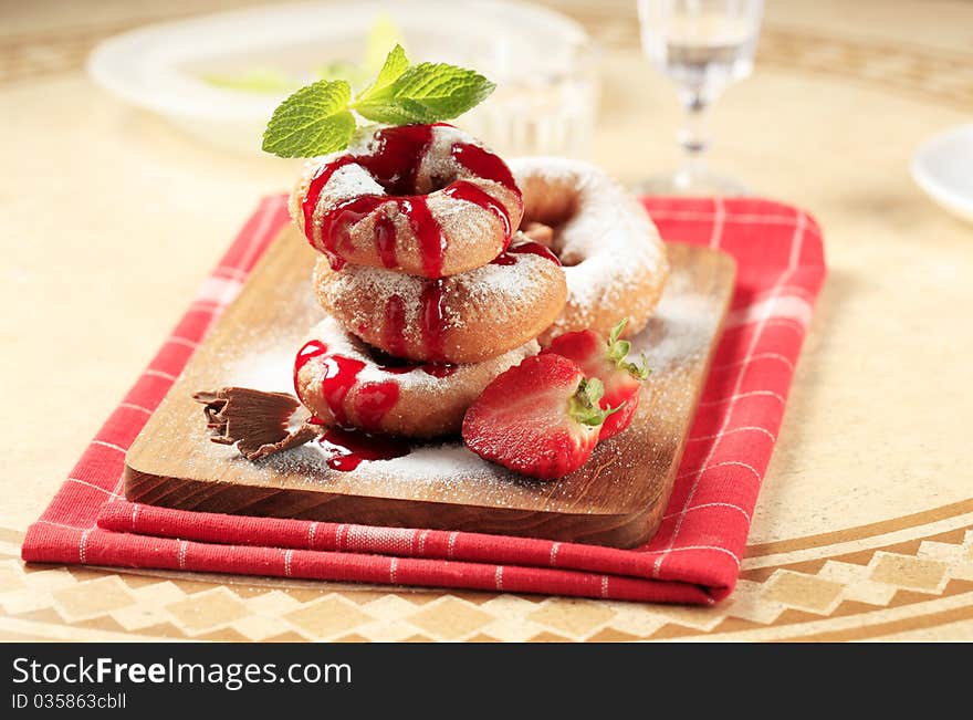 Ring doughnuts poured with syrup - closeup