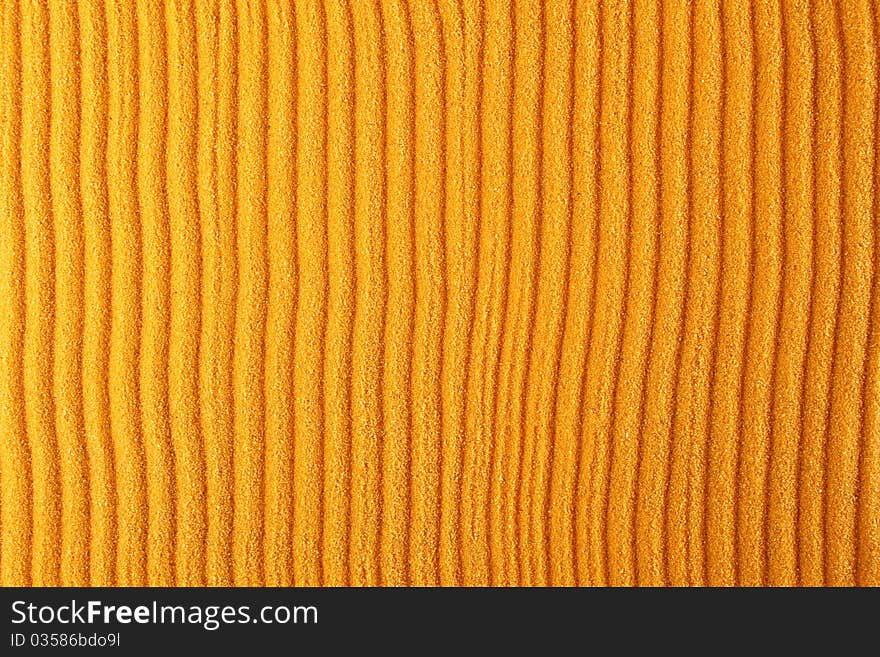 Texture of the orange sand which rakes made strips. Background