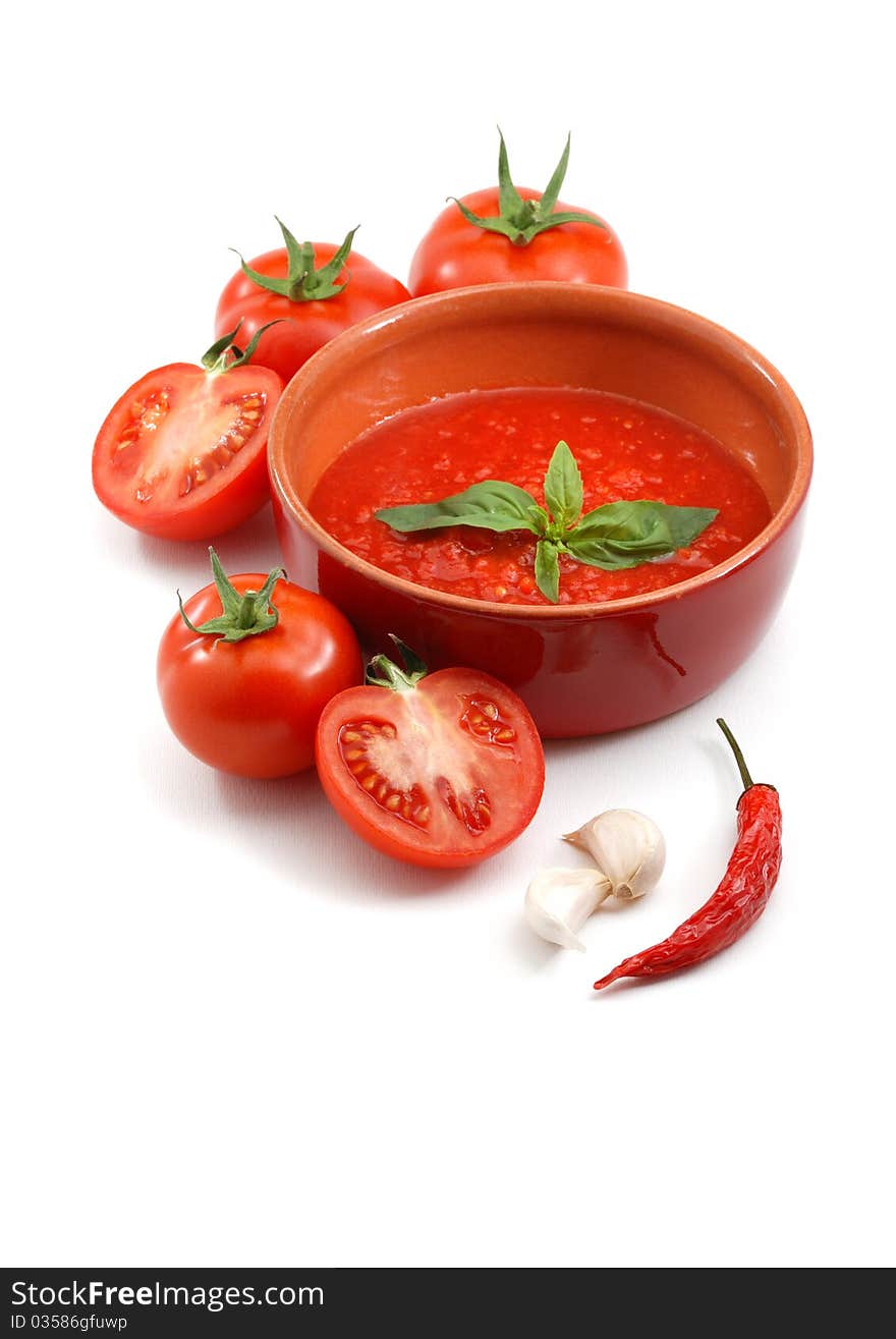 Tomatoes, peppers, garlic,  and basil over white. Tomatoes, peppers, garlic,  and basil over white