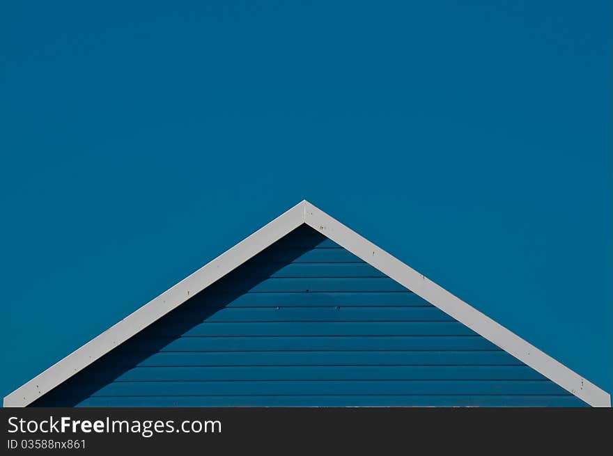 Blue beach hut roof against blue sky