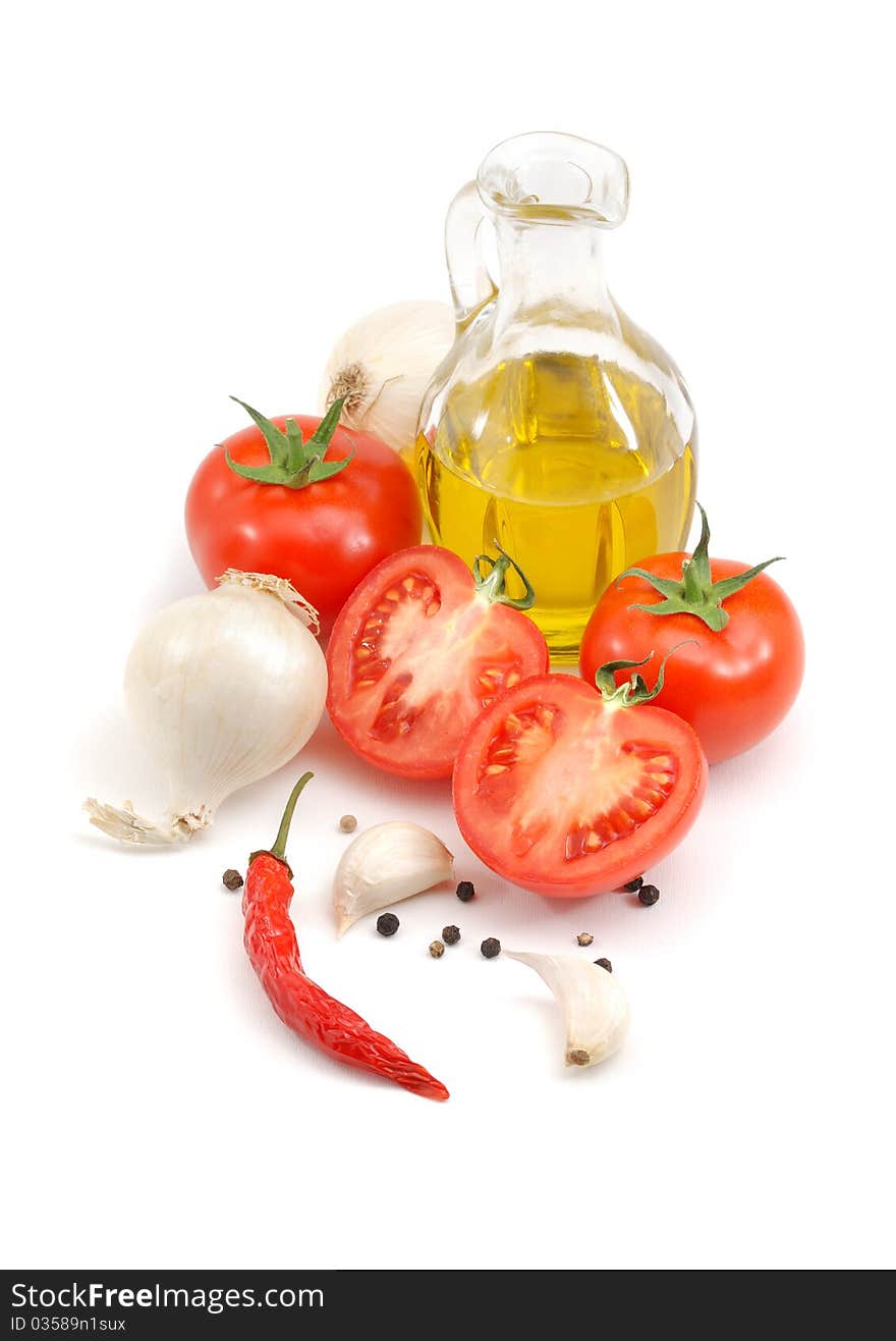 Tomatoes, onions, peppers, garlic, olive oil and basil over white. Tomatoes, onions, peppers, garlic, olive oil and basil over white