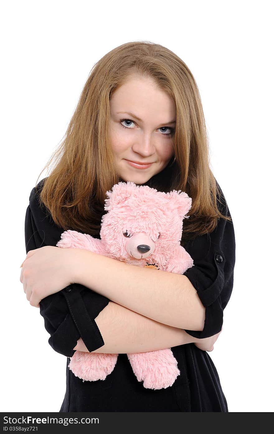 Beautiful girl  embraces teddy bear. On a white background