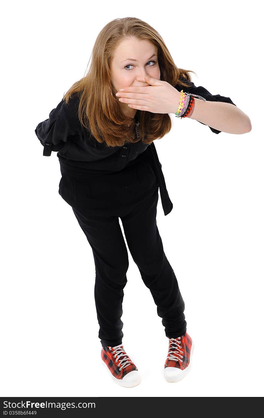 Teenage girl with hand over mouth on a white background