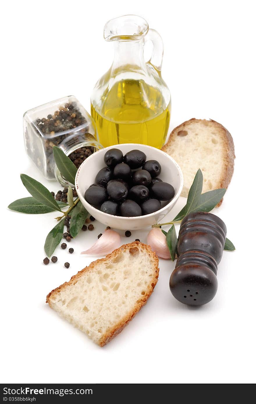 Olives, oil, garlic, salt and bread over white. Olives, oil, garlic, salt and bread over white