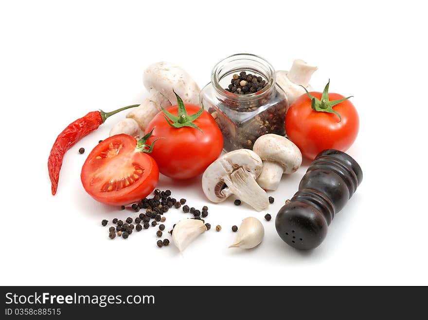 Tomatoes, mushrooms, peppers, garlic and salt over white. Tomatoes, mushrooms, peppers, garlic and salt over white