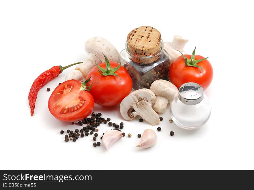 Tomatoes, mushrooms, peppers, garlic and salt over white. Tomatoes, mushrooms, peppers, garlic and salt over white