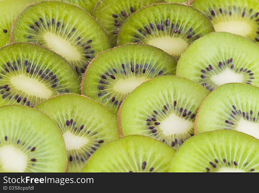 Fresh kiwi slices, green fruits background