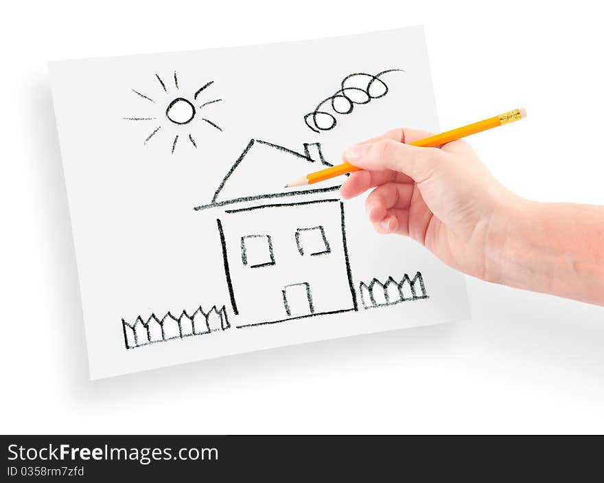 Woman's hand with the pencil drawing the dream home on a white sheet of paper