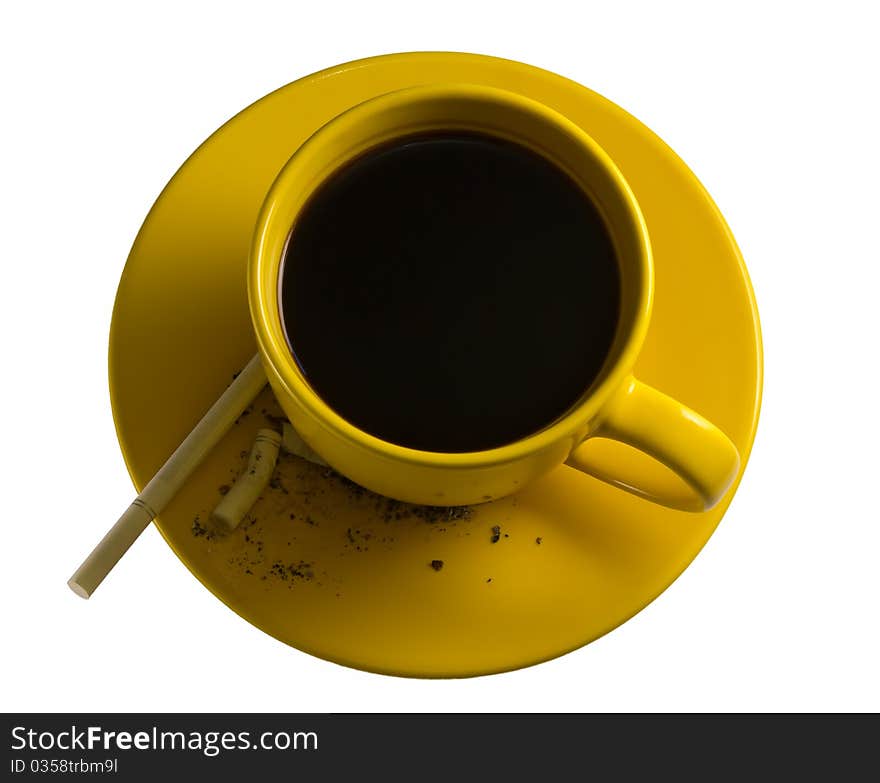 Yellow cup of coffe with cigarettes. Two most addictions in many countries. There is also a cigarette ash on the saucer.