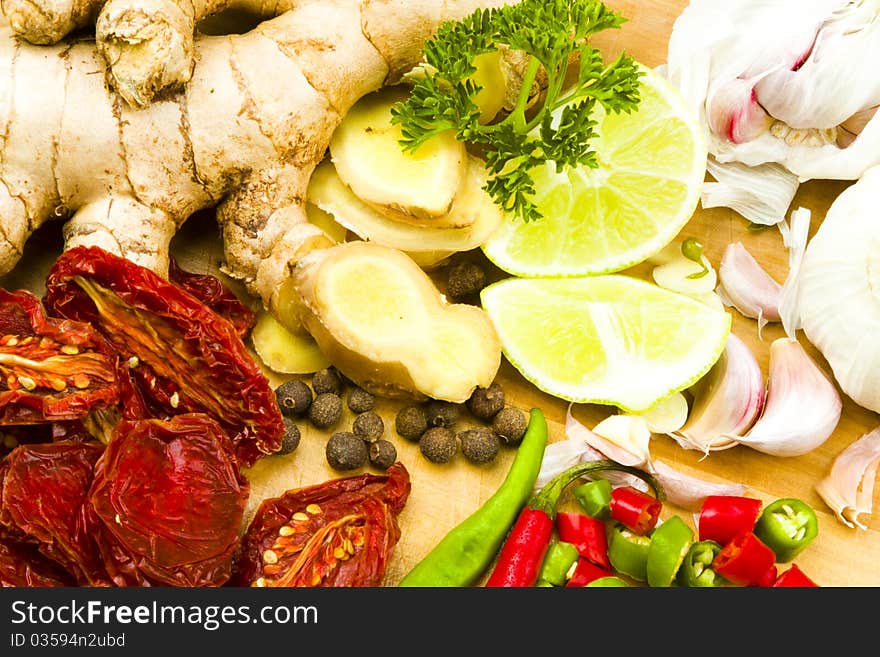 Raw garlic, ginger rhizome, red and green whole fresh chillies with limes, sun-dried tomato, allspice and fresh parsley. Raw garlic, ginger rhizome, red and green whole fresh chillies with limes, sun-dried tomato, allspice and fresh parsley