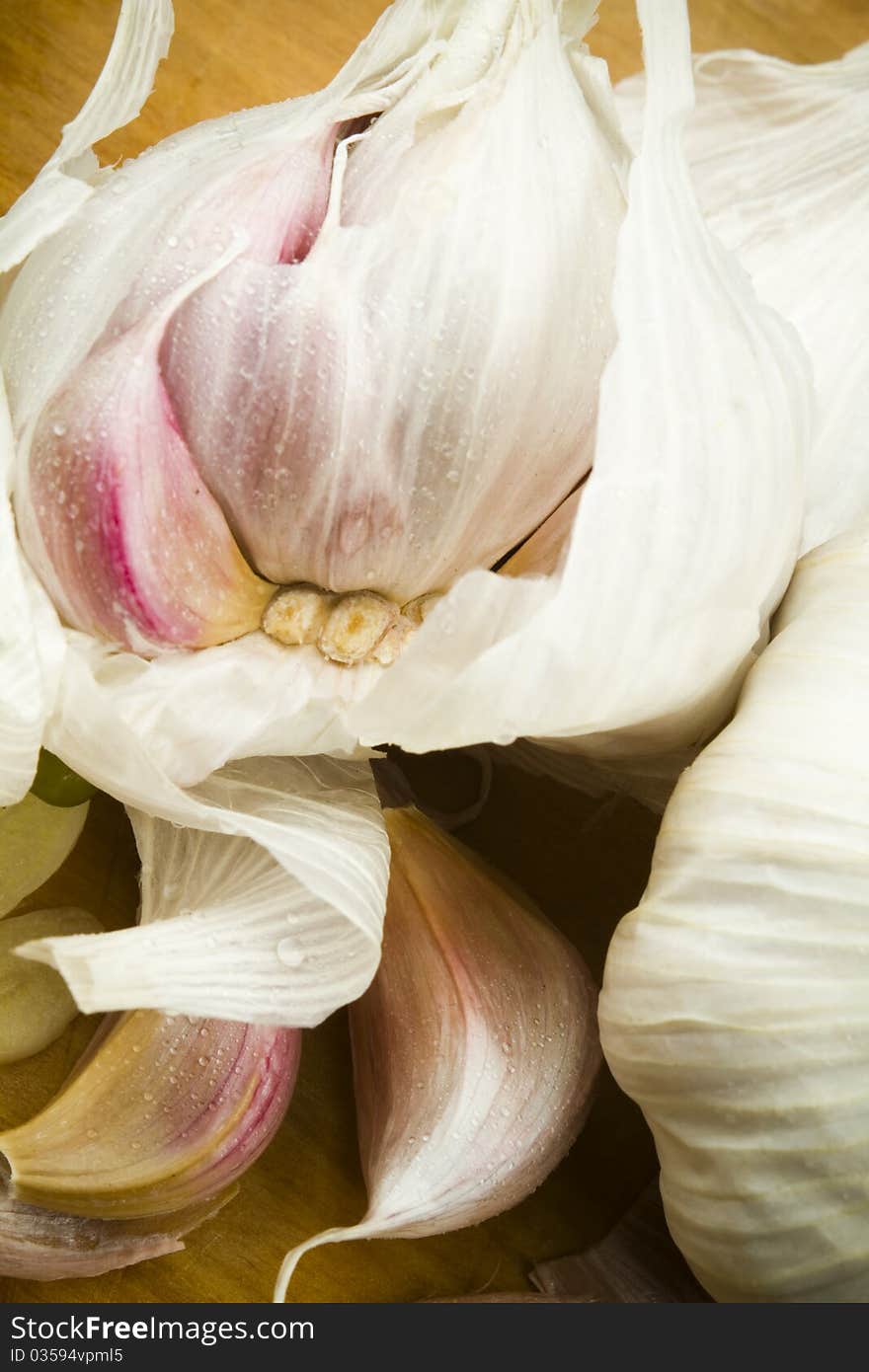 Marketfresh organic garlic cloves on a wooden table surface