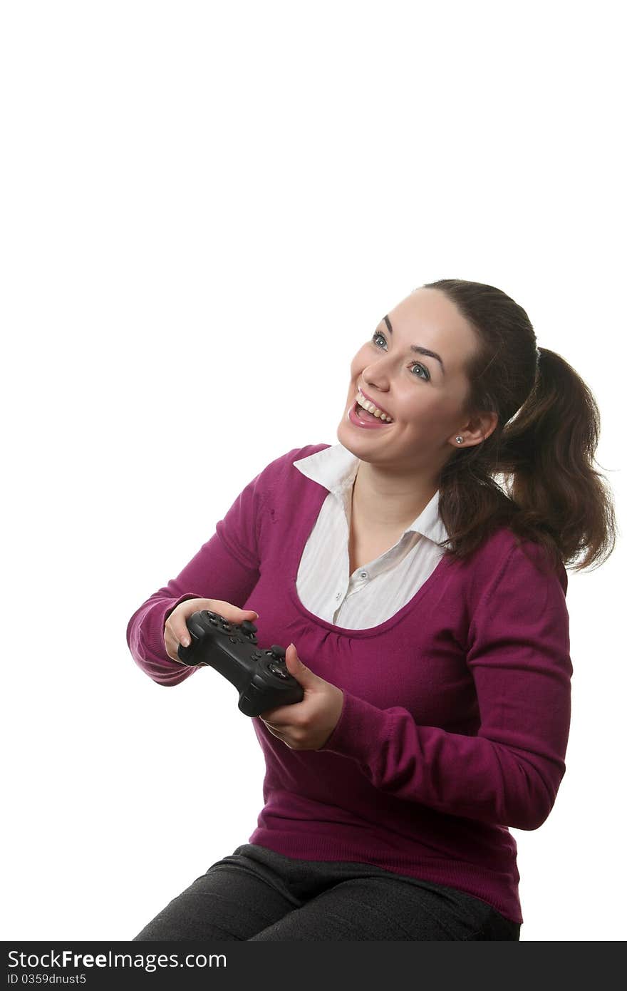 Young women play wideogame by gamepad on the white isolated background. Young women play wideogame by gamepad on the white isolated background