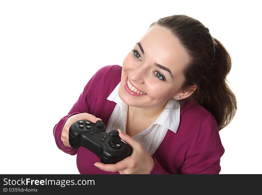 Young women play wideogame by gamepad on the white isolated background. Young women play wideogame by gamepad on the white isolated background