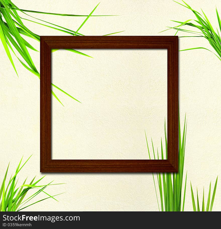 Wood frame on fresh grass background