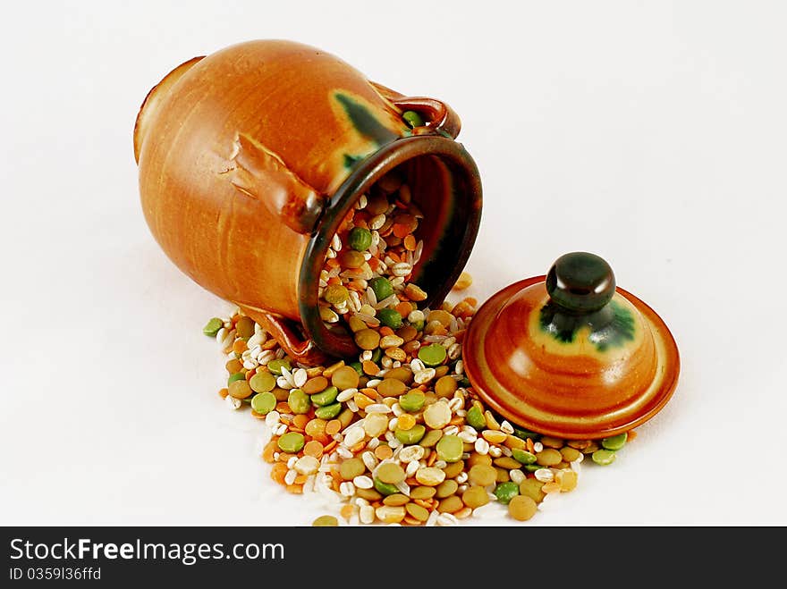 Ceramic jug with grain on white background. Ceramic jug with grain on white background