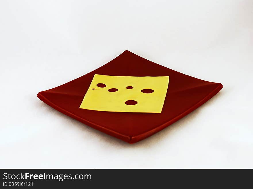 A slice of cheese on brown plate