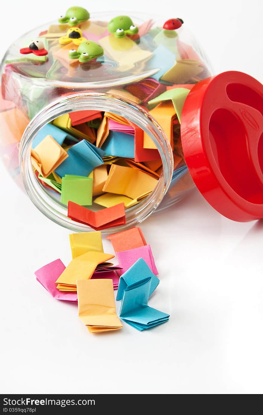 Colorful messages in a glass jar isolated in white