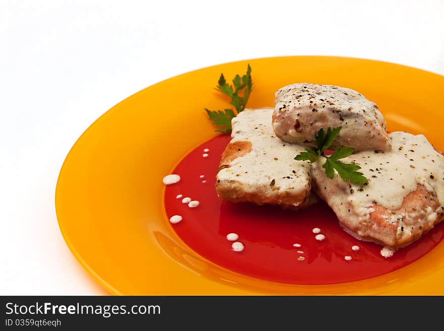 Grilled salmon with cream sauce and parsley isolated in white