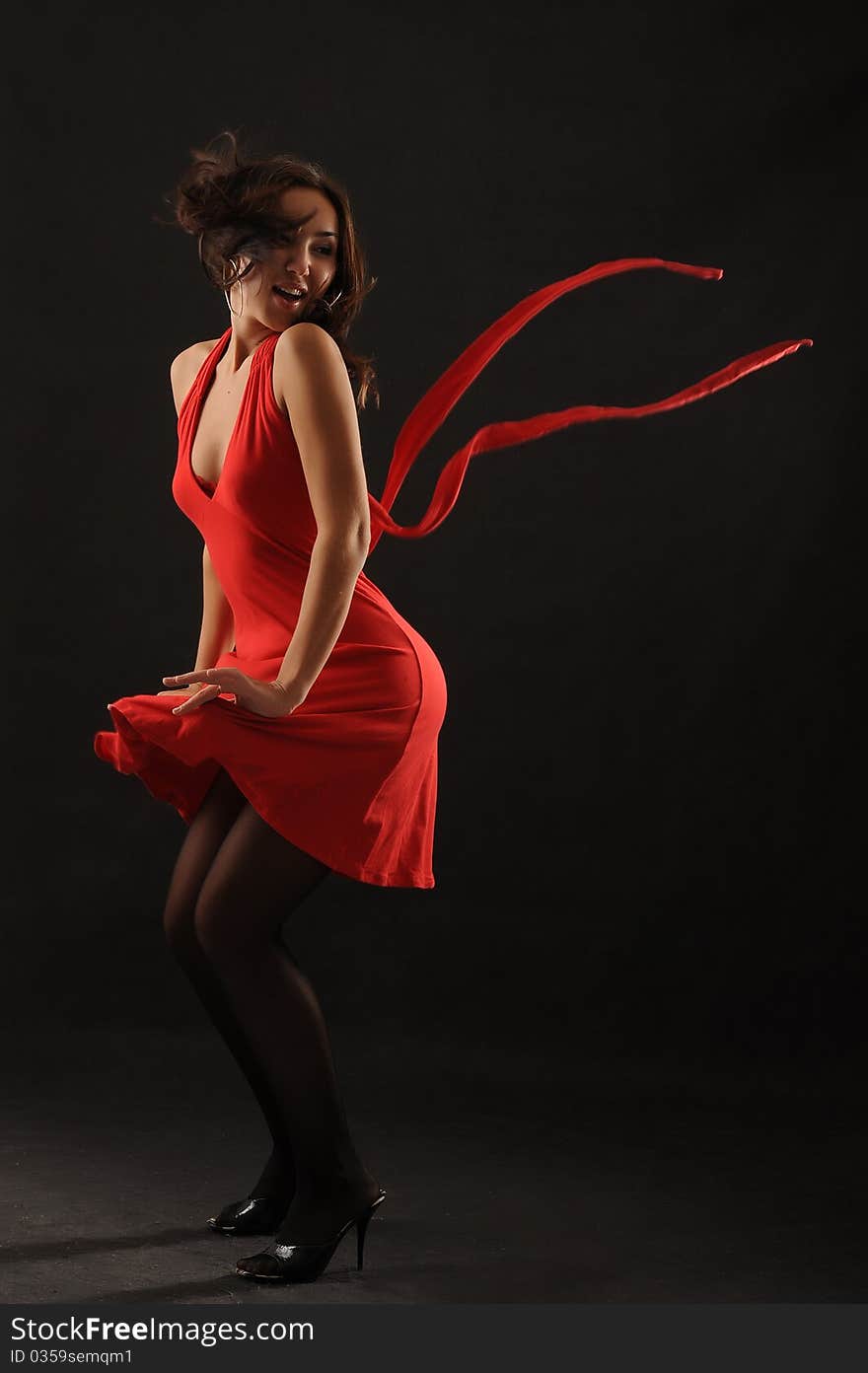 Beautiful asian girl  in red dress over black background