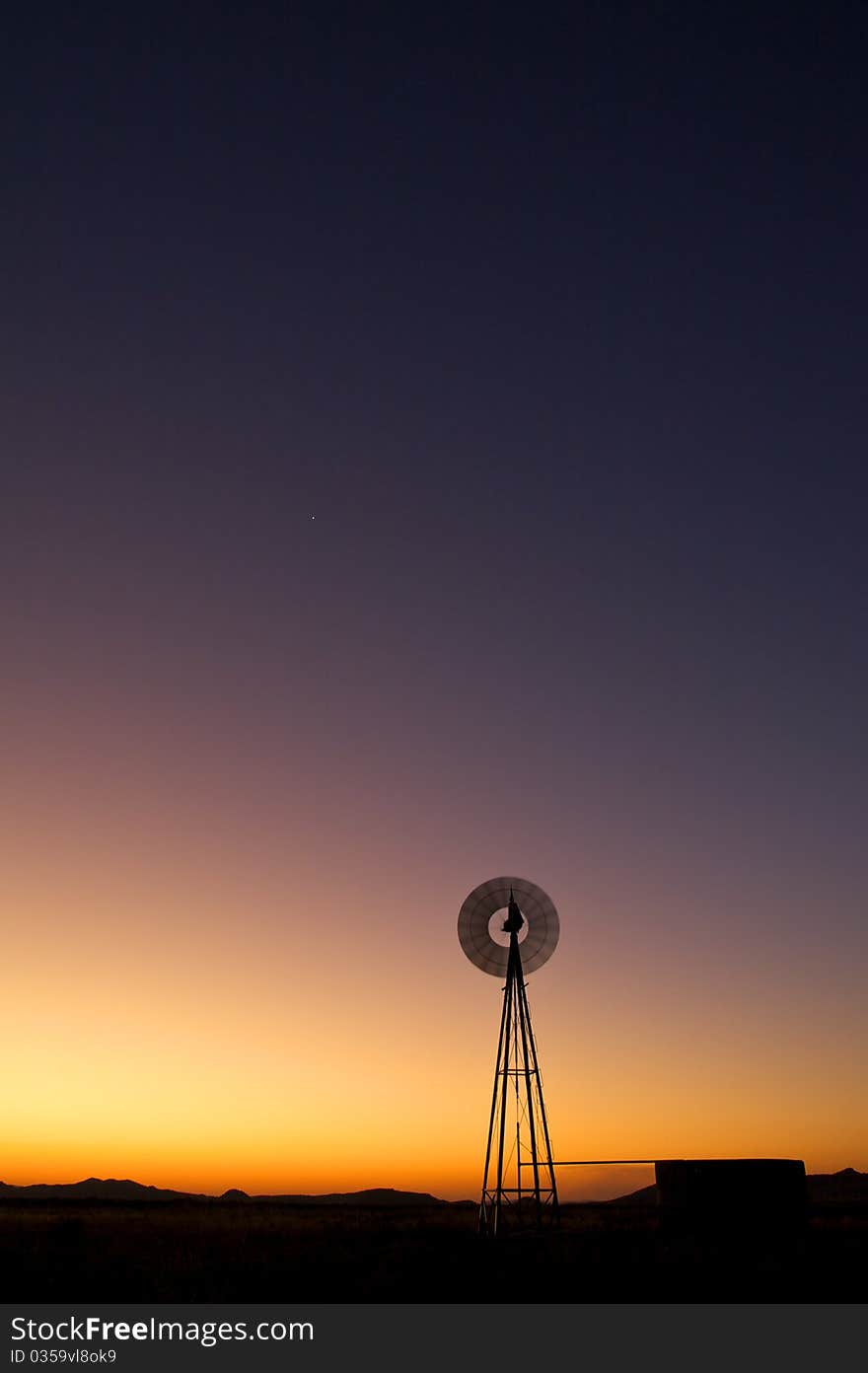 Windmill at sunset in clearing. Windmill at sunset in clearing