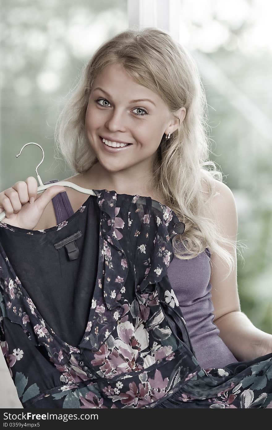 Portrait of young nice woman with dress on color back