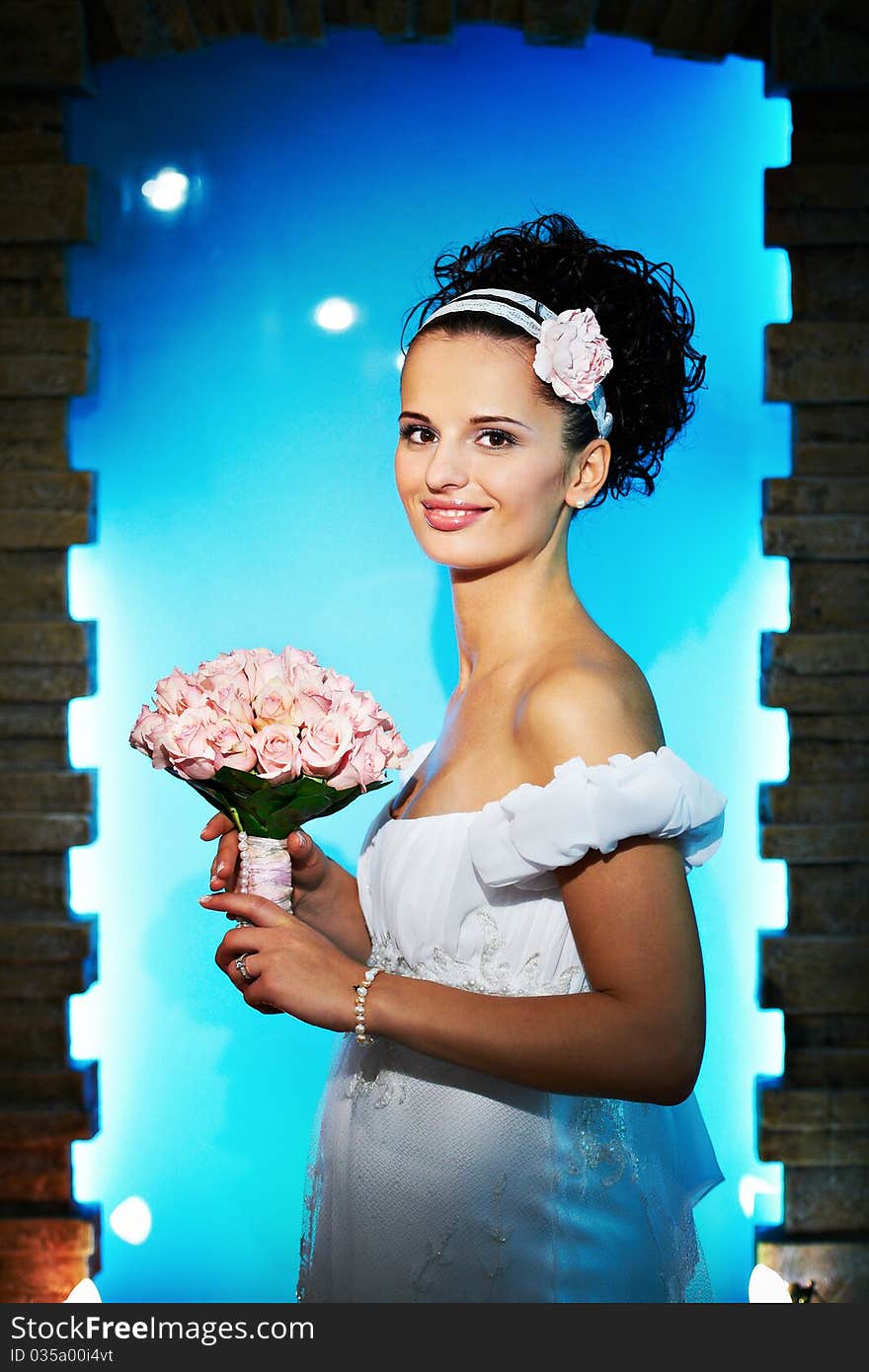 Portrait beautiful bride with bouquet of flowers on blue background in wedding day. Portrait beautiful bride with bouquet of flowers on blue background in wedding day