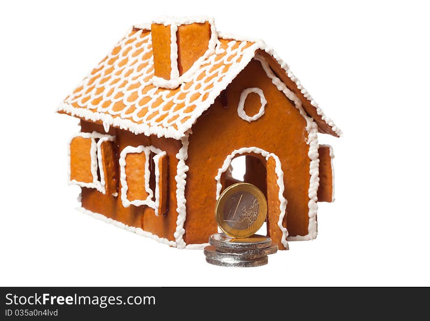 Isolated christmas gingernut house and euro coins