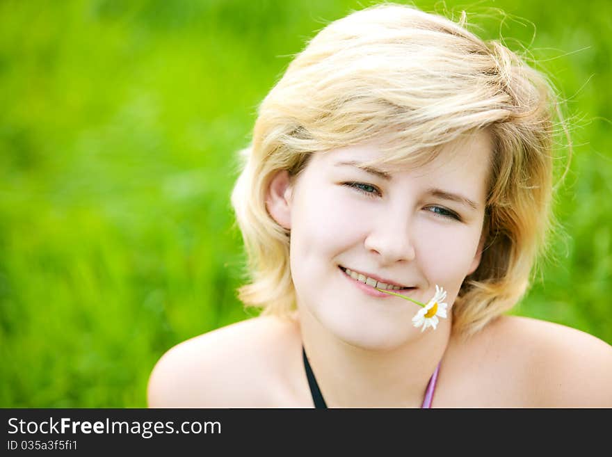 Young beautiful girl on a meadow