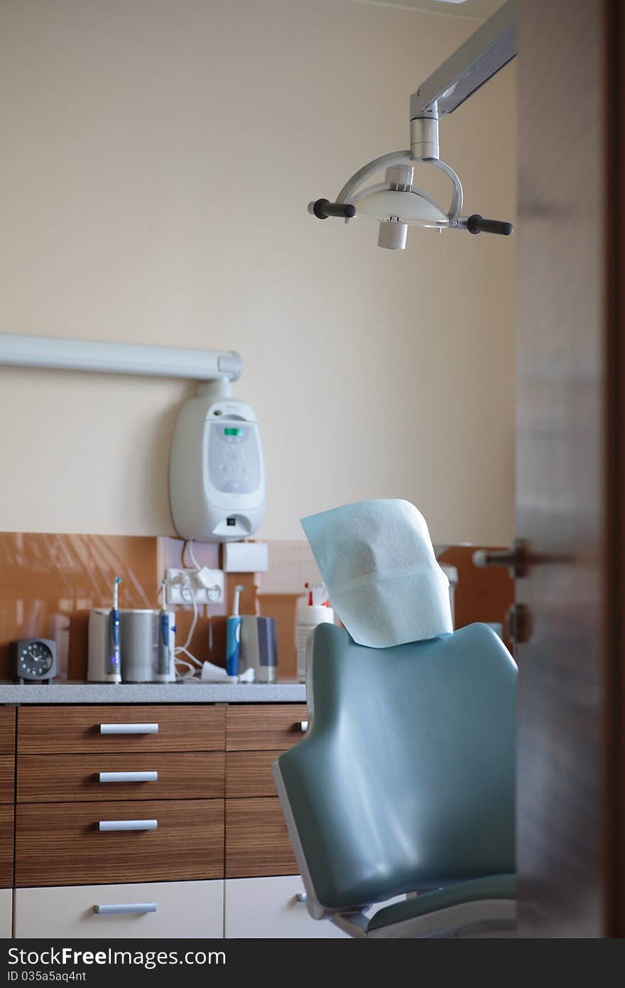 Modern dentist's chair in a medical room. View on open door. Modern dentist's chair in a medical room. View on open door