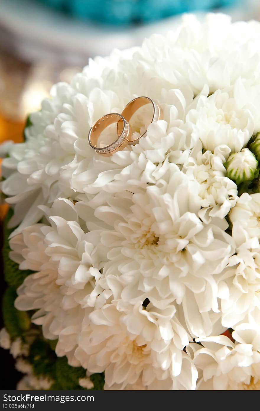 Gold bridal rings on flowers