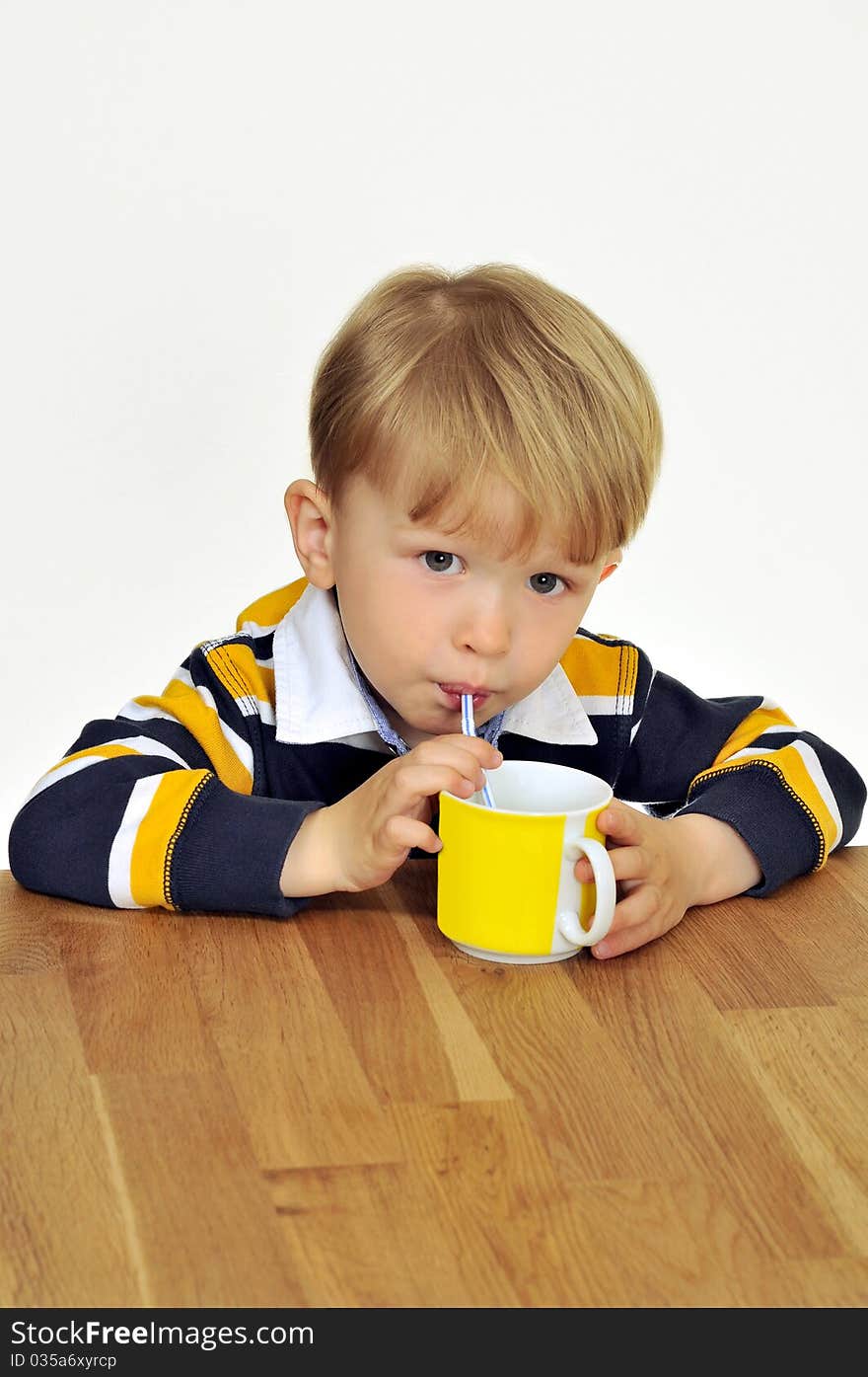 A child drinking a beverage through a straw. A child drinking a beverage through a straw