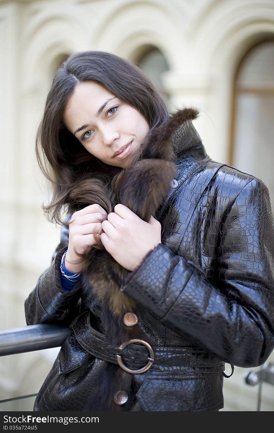 Young girl hiding a fur collar