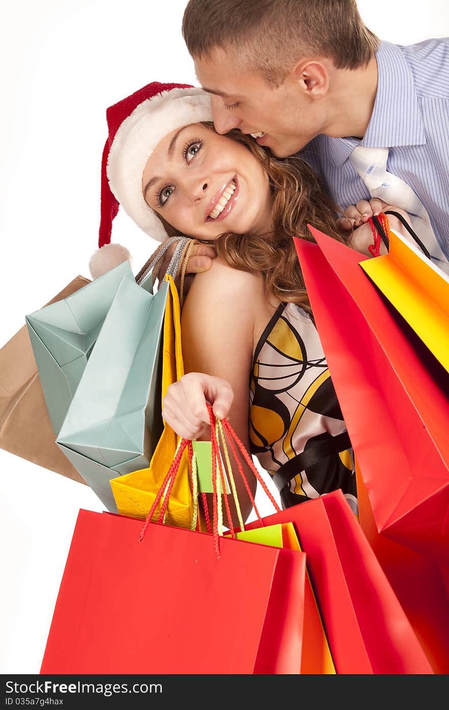 Lovely couple making christmas shopping. Isolated on white.