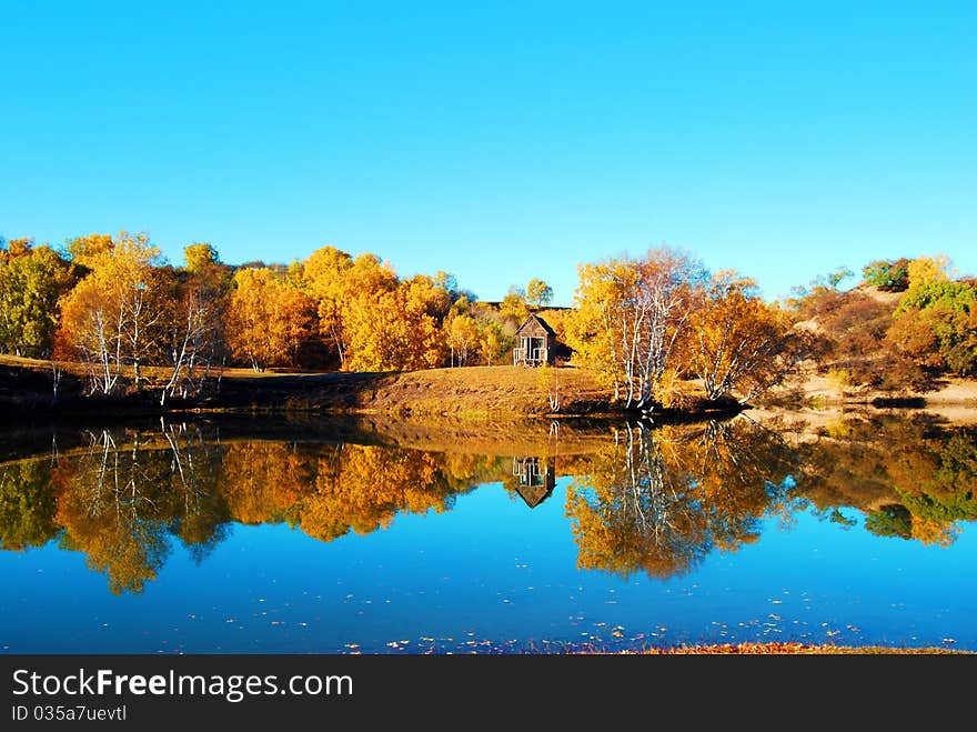 Grass with house beside the lake and cloud under blue sky. Grass with house beside the lake and cloud under blue sky.