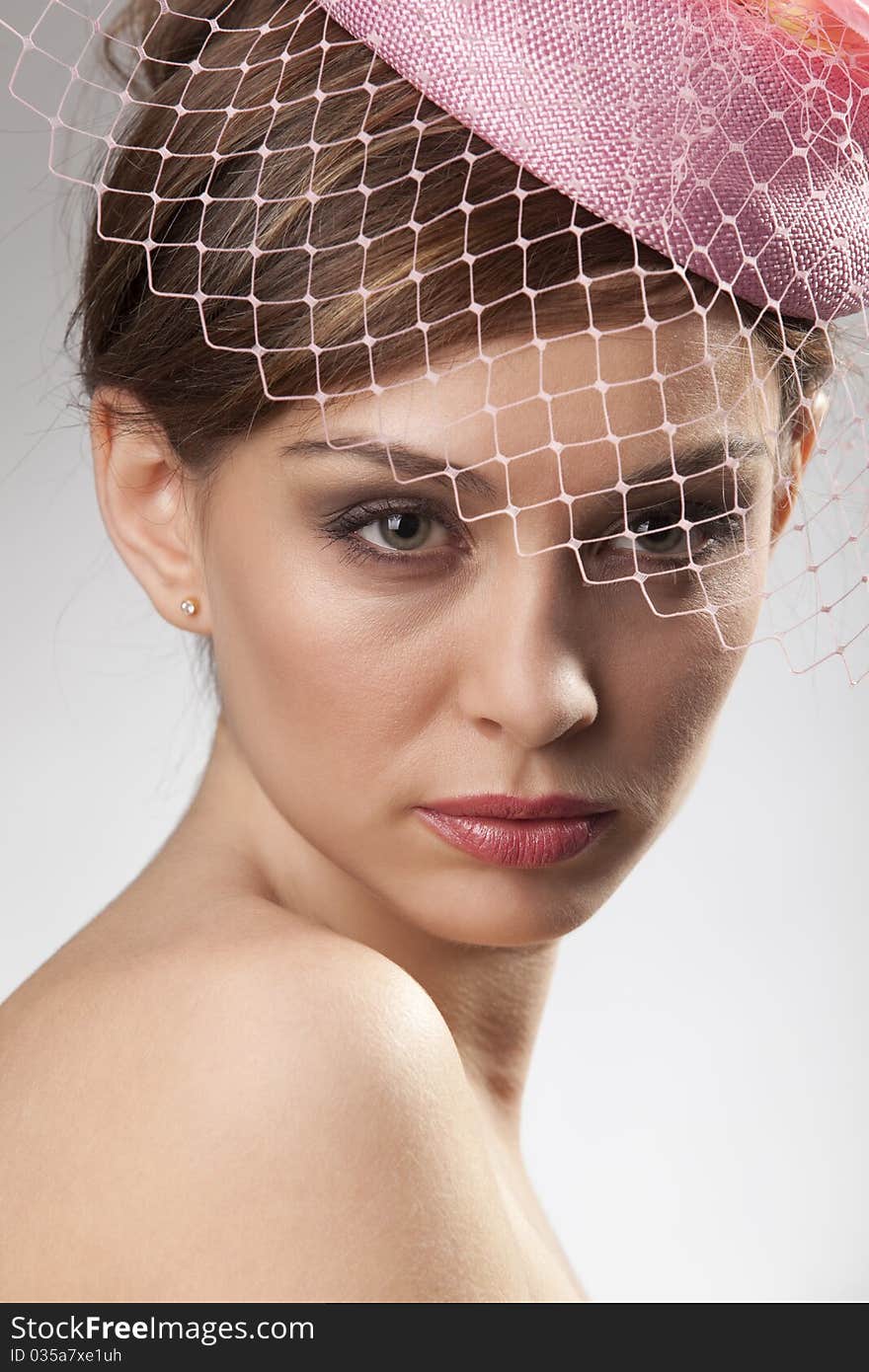 Portrait of pretty young woman in pink bonnet with voile. Vintage Make-up