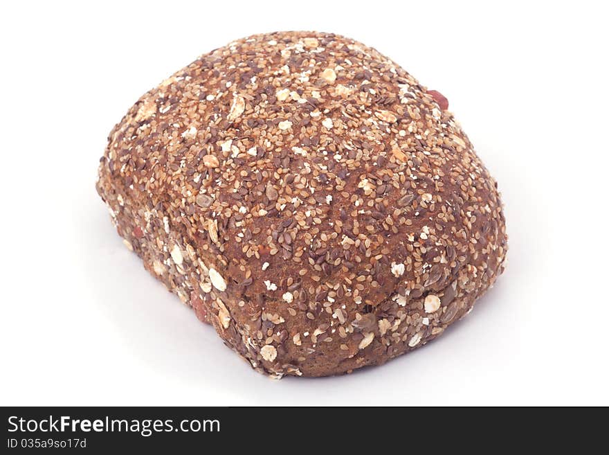 A piece of bread with many seeds isolated on white background.