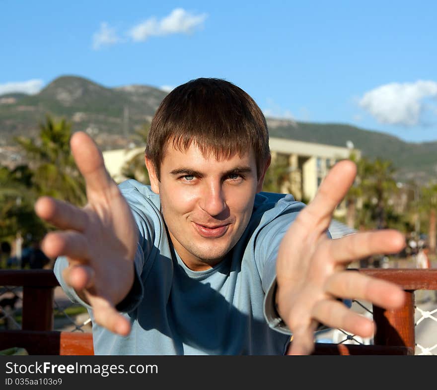 Portrait men on nature, pulls hands to spectator